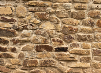 Background in the form of a stone wall from a boot of light brown color