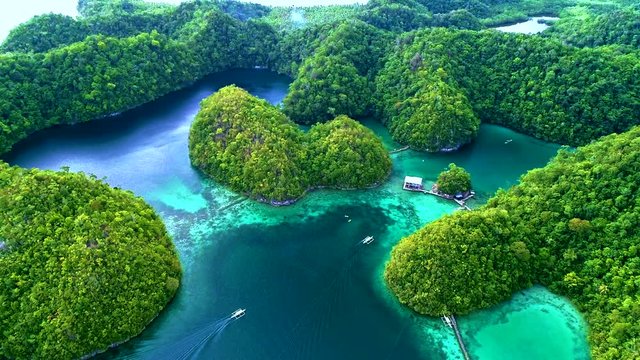 Tropical landscape rainforest hills and azure water in lagoon with clouds on the Siargao island, Philippines. Drone Aerial view 4Kl