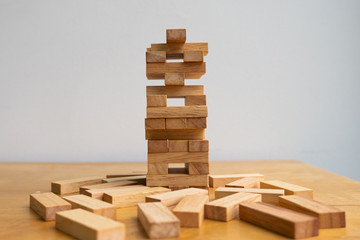 Wood block tower with architecture model, Concept Risk of management and strategy plan, growth business success process and team work