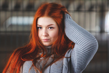 portrait of offended young girl with bright red hair, retro toned