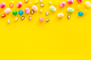 Sweets pattern on yellow background top view copyspace