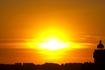 Red sunset (solar blast), sun at clouds, city silhouette