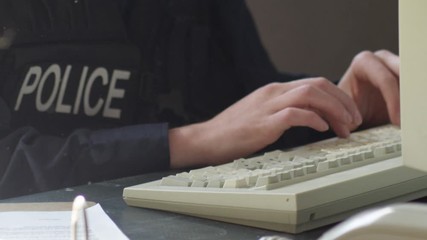 Police officer in precinct solving crimes