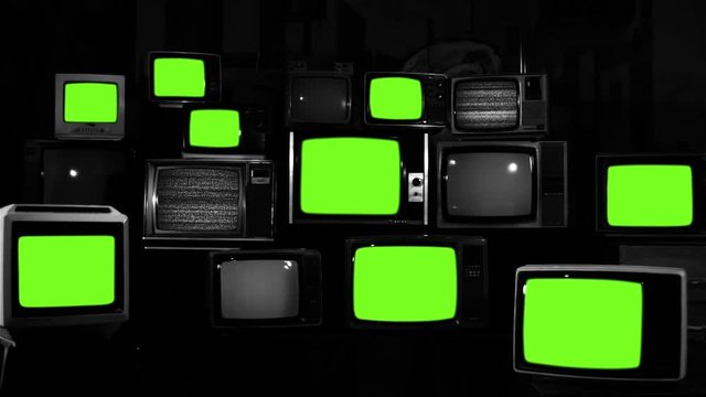 Stacked retro TVs turning on Green Screens. Black and White Tone. You can replace green screen with the footage or picture you want with &ldquo;Keying&rdquo; effect in AE (check out tutorials on Internet).