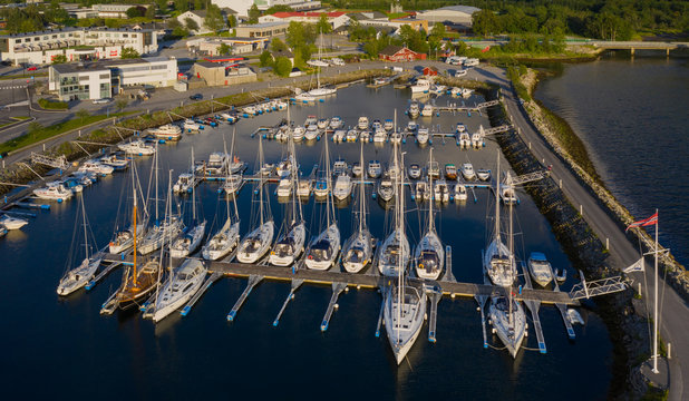 Aerial view of a lot of white boats and yachts moored in marina. Photo made by drone from above. july 2019, Norway, &Oslash;rstafjorden(Orstafjord), &Oslash;rsta(Orsta), Norway