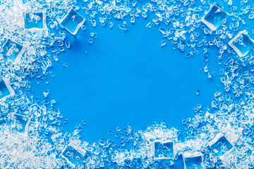 Frozen water in ice cubes frame on blue bar table top view mock-up