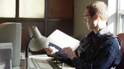 Police officer in precinct solving crimes