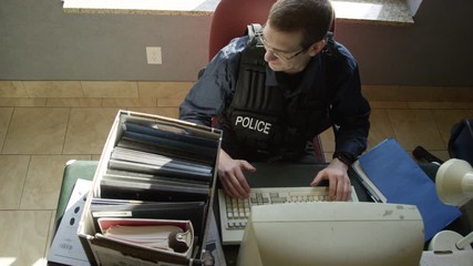 Police officer in precinct solving crimes