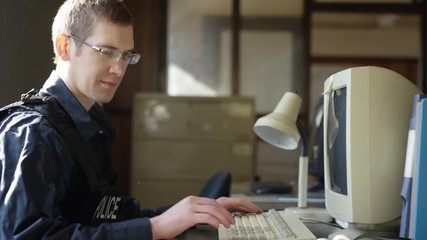 Police officer in precinct solving crimes