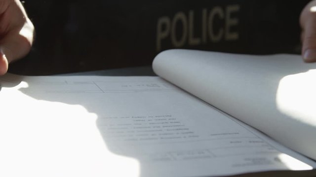 Police officer in precinct solving crimes