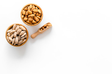Almond in bowl on white background top view space for text