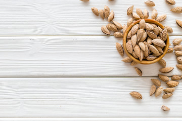 Healthy snack with almonds on white wooden background top view mock up