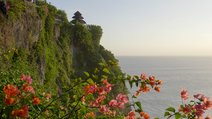 uluwatu temple with bougainvillea flowers on bali
