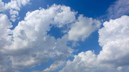 Beautiful bright blue sky with white fluffy clouds on a clear sunny day. Royalty high-quality free stock photo image of blue sky with white cloud, nice weather. Photo of natural cloudscape background