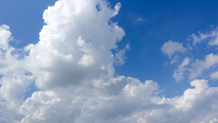 Naklejka na ściany i meble Beautiful bright blue sky with white fluffy clouds on a clear sunny day. Royalty high-quality free stock photo image of blue sky with white cloud, nice weather. Photo of natural cloudscape background