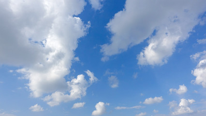 Beautiful bright blue sky with white fluffy clouds on a clear sunny day. Royalty high-quality free stock photo image of blue sky with white cloud, nice weather. Photo of natural cloudscape background