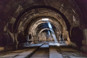 Fototapeta na wymiar Smoke makes the light shafts visible in the Selim Caravanserai waypoint in Armenia along the Silk Road, built in 1332 AD
