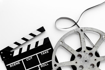 Go to the cinema with film type and clapperboard on white background top view