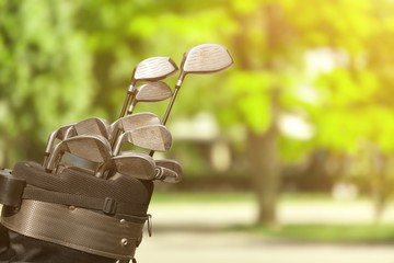 Different golf clubs on  background.