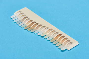 teeth samples with different shades isolated on blue