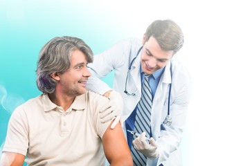 Handsome doctor making vaccination to male patient on background