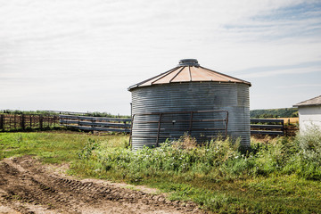 Fototapeta na wymiar old silo on a country dirt road on a farm