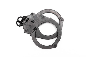 Black handcuffs isolated on the white background.