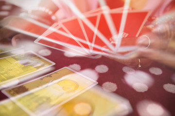 Tarot cards reading divination - Psychic readings and clairvoyance fortune teller hands concept , with effect filter blur selective focus