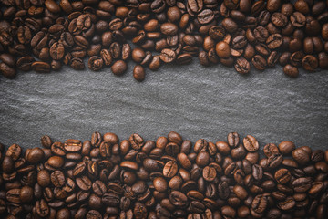 Coffee beans on dark background top view with place text copy space