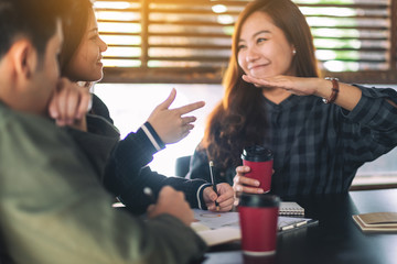 Group of businesspeople working and making hand sign to explain business detail in a meeting