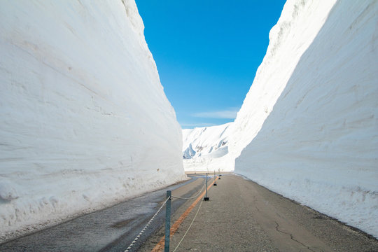 The japan alps  or the snow mountains wall  of Tateyama Kurobe alpine  in sunshine day with  blue sky background is one of the most important and popular natural place in Toyama Prefecture, Japan.
