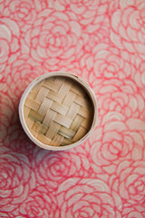 Mini Bamboo Dumpling Steamers on red tray, top view