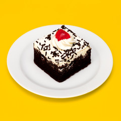 Chocolate Cake on yellow background. Flat lay food vanilla candy art