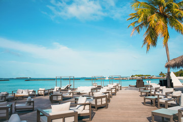 Amazing island beach resort and hotel in the Maldives , beautiful  turquoise waters with  blue sky  background for holiday vacation .