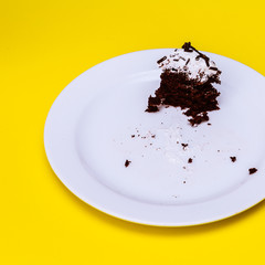 Cake leftovers on yellow background. Flat lay food vanilla candy art