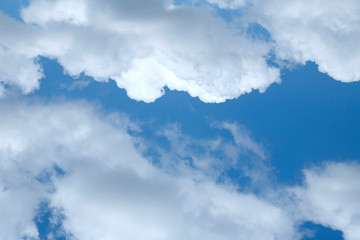 Background of blue sky with white fluffy clouds. Cropped shot, horizontal, outdoors, nobody. Concept of nature and ecology.