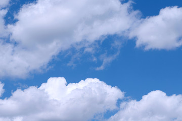 Background of blue sky with white fluffy clouds. Cropped shot, horizontal, outdoors, nobody. Concept of nature and ecology.