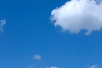 Obraz premium Background of blue sky with white fluffy clouds. Cropped shot, horizontal, outdoors, nobody. Concept of nature and ecology.