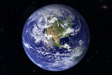 The mother Earth, against the background of the star sky, with the far galaxy. Elements of this image were furnished by NASA