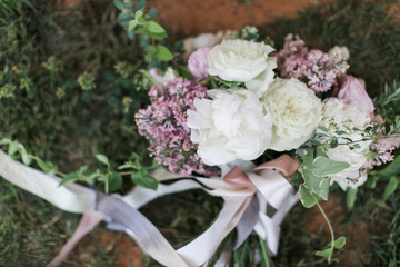 Modern wedding bouquet with white peonies and pink and purple flowers, silk ribbon greenery, close up