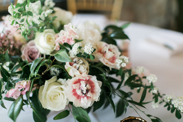 Close up of modern wedding flowers on table, reception table decoration, white, pink, and green flowers