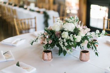 Modern wedding flowers on table, rose gold candle holders, reception table decoration, white, pink, and green flowers