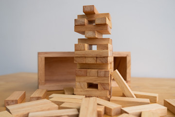 Wood block tower with architecture model, Concept Risk of management and strategy plan, growth business success process and team work