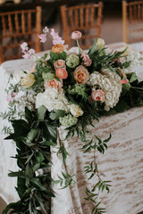 Flowers and Garland on Table at wedding reception, Greenery and florals wedding decor, modern and trendy 