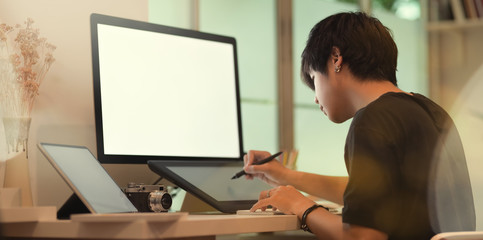 Young professional male photographer retouching his picture