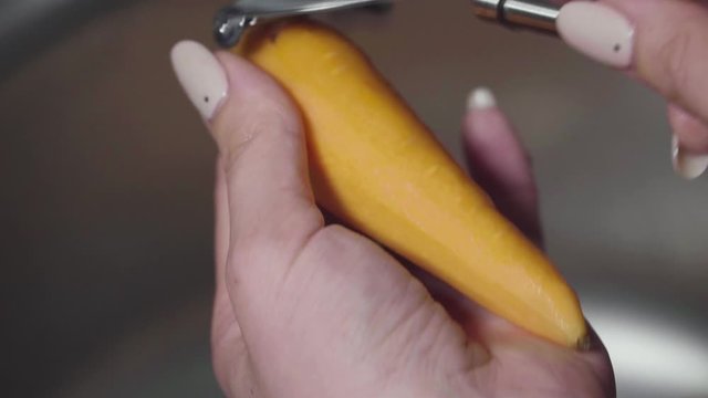 Women's hands wash, peel and cut vegetables into vegetable stew.