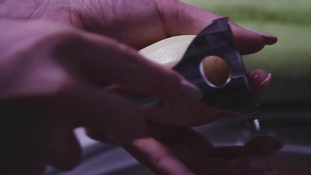 Women's hands wash, peel and cut vegetables into vegetable stew.