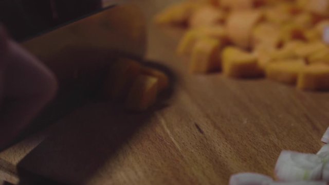 Women's hands wash, peel and cut vegetables into vegetable stew.