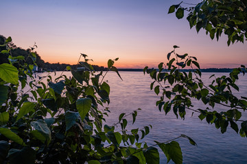 Sunset at the beach and woods in Barrie Ontario Canada with lake view, river, trees, stone formation, and light