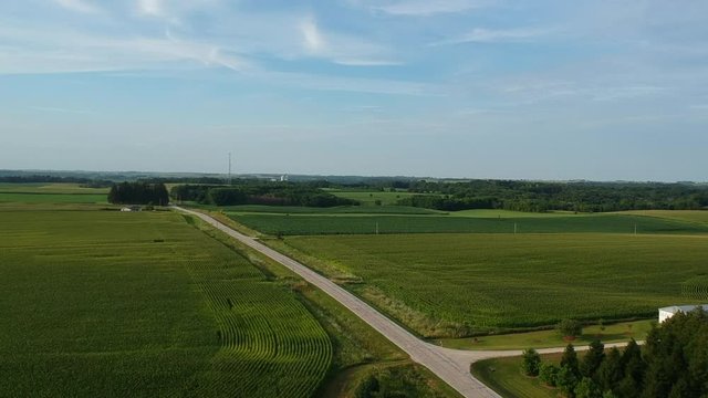 Drone footage over a rural Iowa corn field at sunset